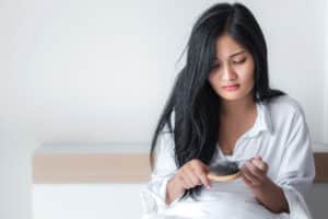 Attractive,Asian,Woman,Serious,About,Her,Brush,For,Presentation,Hair